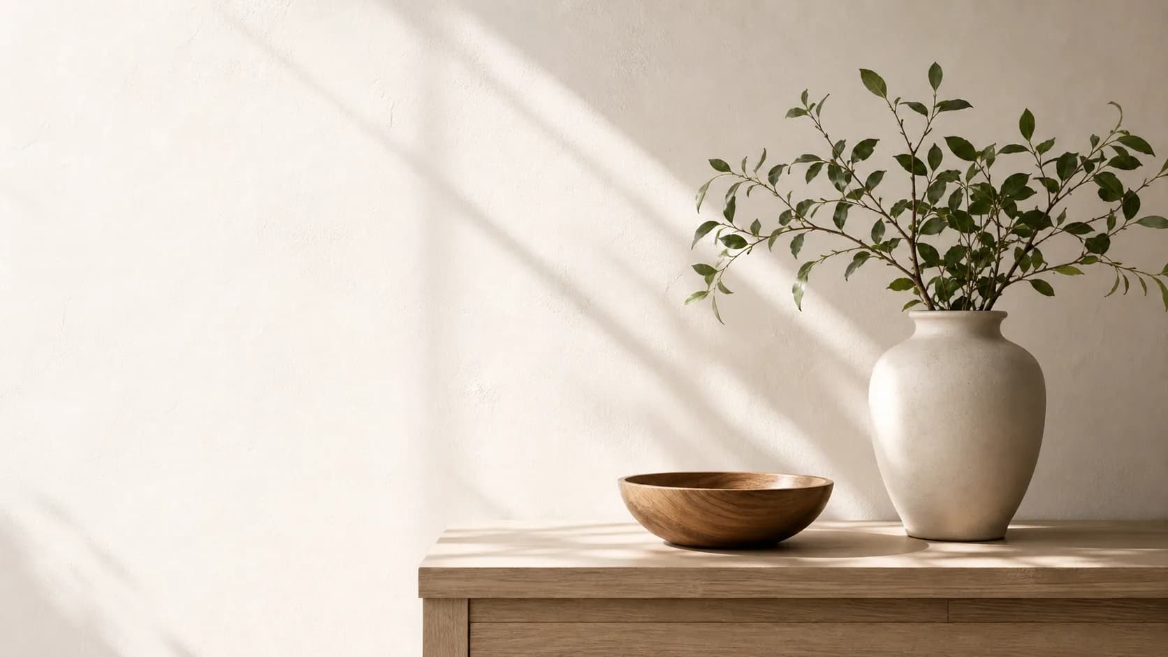 Sunlit modern home with a ceramic vase and green branches